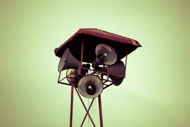 Old public loudspeakers broadcast on high tower with long distance tower
