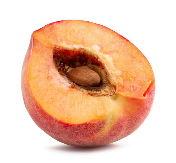 istock half of peach isolated on a white background 825985744