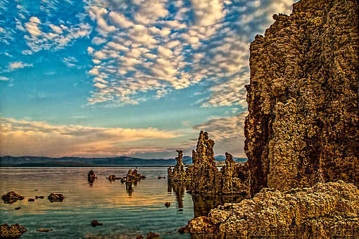 Tufa is a variety of limestone formed when carbonate minerals precipitate out of ambient temperature water. Geothermally heated hot springs sometimes produce similar carbonate deposits known as travertine. These are beautiful spires coming out of the water. This image was taken with a Nikon D3s and a Tamron 16 - 300mm lens. This image will delight all that sees it hanging in your home or office.