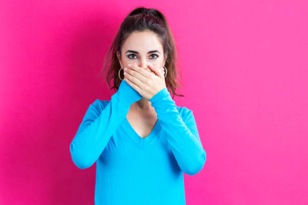 istock Young woman covering her mouth 825989226