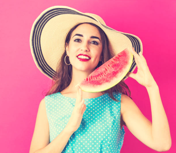 istock Happy young woman holding watermelon 825989288