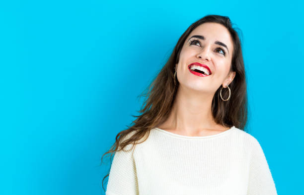 istock Happy young woman on a blue background 825989390