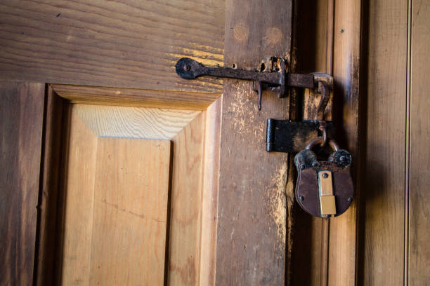 istock Antique Padlock On Wooden Door 825990092