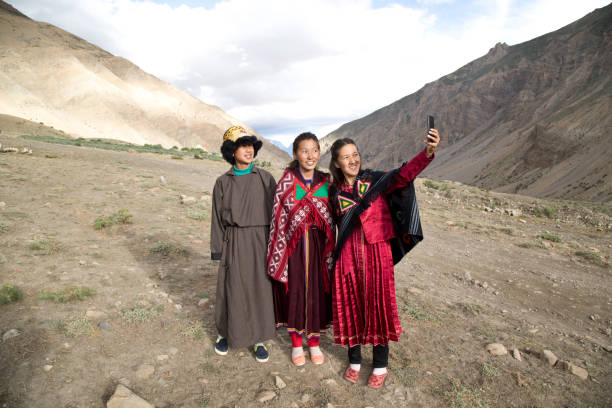 istock Buddhist man and women taking a selfie using smart phone 825990360