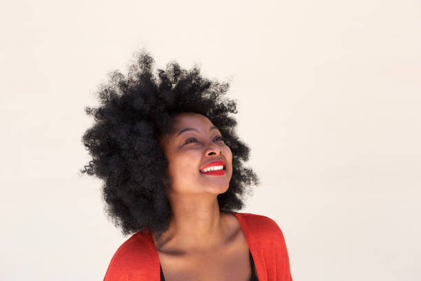 istock african young woman smiling and looking up 825992888