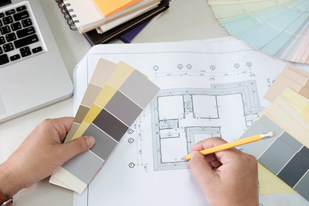 istock Graphic design and color swatches and pens on a desk. Architectural drawing with work tools and accessories. 825993796