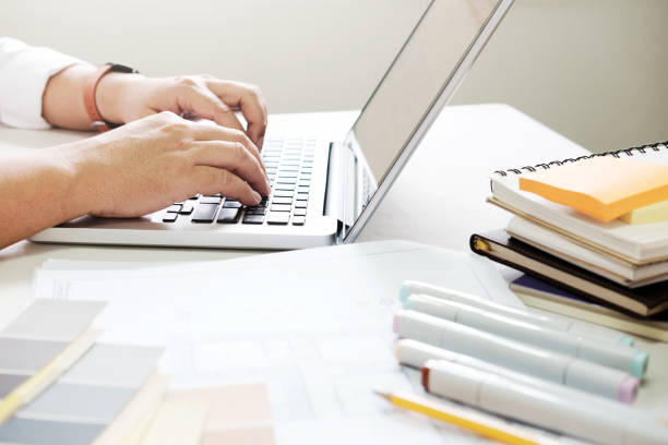 istock Graphic design and color swatches and pens on a desk. Architectural drawing with work tools and accessories. 825993800