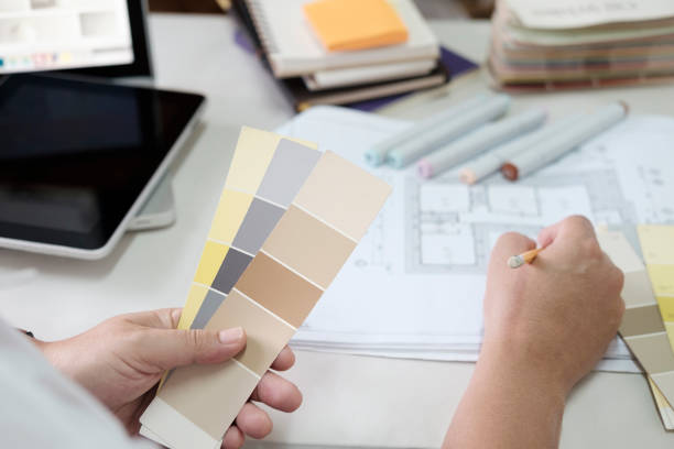 istock Graphic design and color swatches and pens on a desk. Architectural drawing with work tools and accessories. 825994158