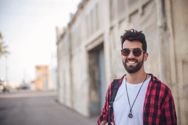 istock Smiling student in plaid shirt 825997840