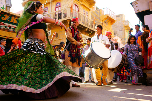 India Jaisalmer - February 8, 2017: A part of the desert festivals held in Jaisalmer, Rajasthan, India, Indian women dressed in bright colors of clothing and dancing folk dances. Desert festivals are usually held every three days and begin in a quarter of the city's color parade.