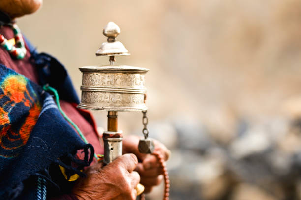 Woman holding prayer wheel and beads Midsection of woman holding hand prayer wheel and prayer beads ladakh region stock pictures, royalty-free photos & images