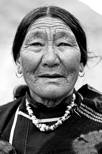 Close-up portrait of elderly woman in traditional clothing