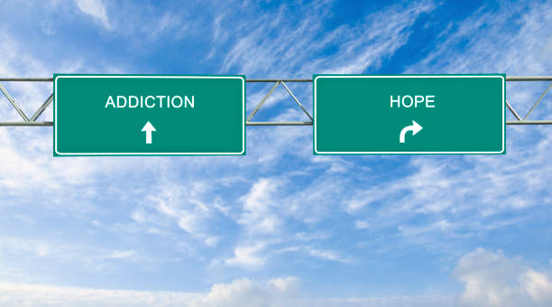 istock Road sign to addiction and hope 826005336