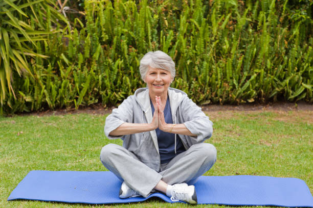 istock Retired woman practicing yoga in the garden 826008724