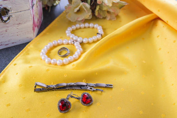 istock Bracelets and earrings and ring on the yellow background 826009064