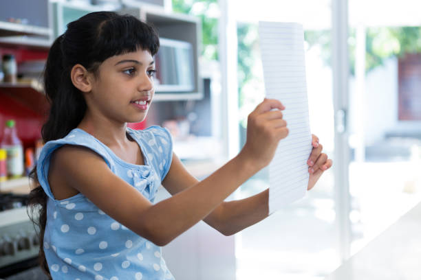 istock Girl reading paper in kitchen 826011182