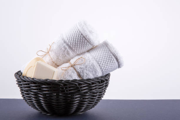 istock Two white towels in a black basket. The background is white. 826019894
