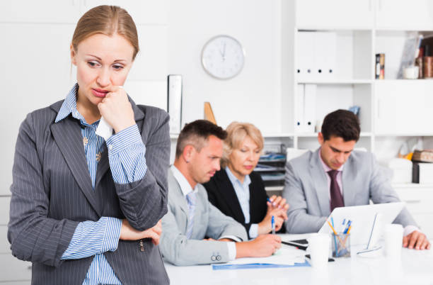 istock Business woman crying in office with working colleagues 826023056