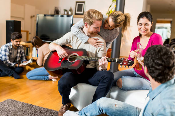 istock Young people having party with guitar 826025548