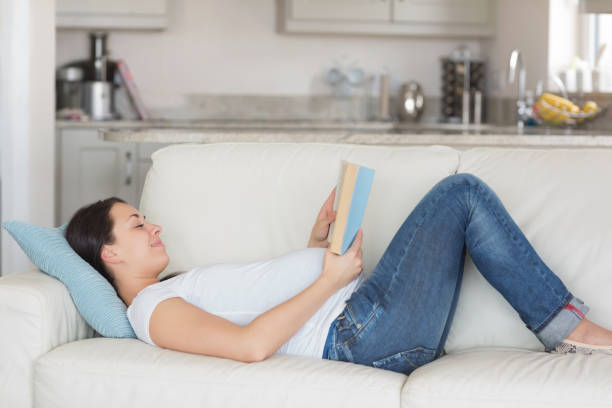 istock Pregnant woman relaxing on sofa 826025616