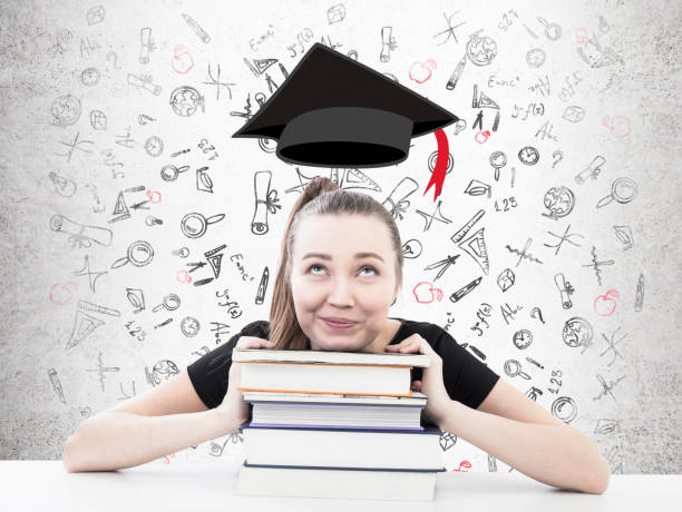 istock Dreamy blond girl with books, graduation 826025866