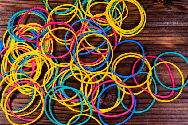 istock Multicolored rubber bands on wooden table. Top view 826028992