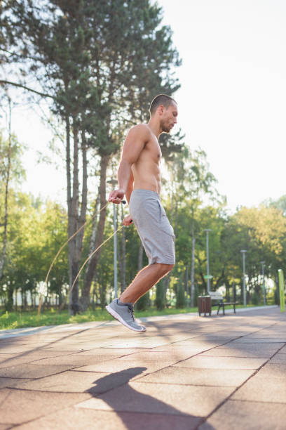 istock Man training with jump rope during his fitness workout routine 826032638