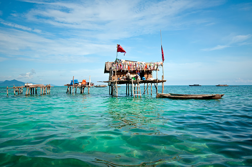 Semporna, Malaysia - 17 September, 2011: A Bajau laut floating village of stilted houses off the coast of Borneo in The Celebes Sea in the vicinity of Sipidan and Tun Sakaran Marine Park.