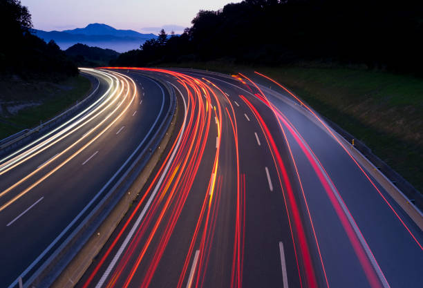 istock Car lights traveling the freeway at dusk 826035304