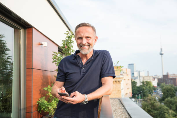 istock Handsome man standing on a balcony in Berlin, Germany 826035992