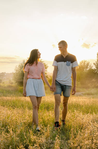 istock young loving couple walking in field 826041280