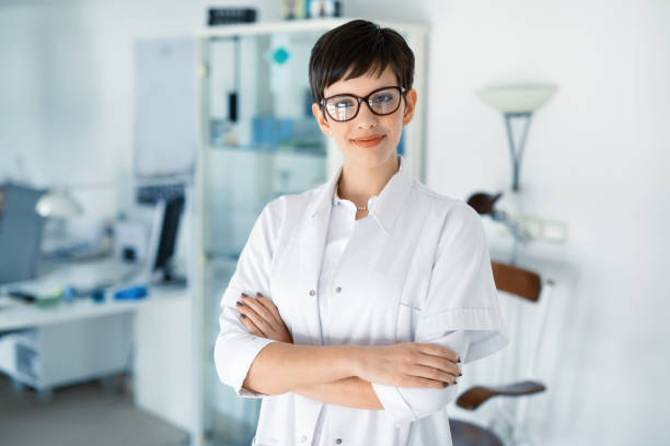 Portrait of female optometrist at eyesight medical clinic Portrait of female optometrist at eyesight medical ophthalmology clinic eye test equipment stock pictures, royalty-free photos & images