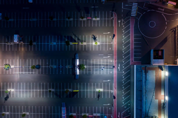 istock Illuminated large parking area at night - aerial view 826051716