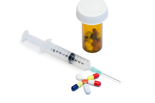 istock Color pills with box pills and syringe 826055606