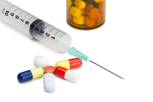 istock Pills with medicine box and syringe 826055612