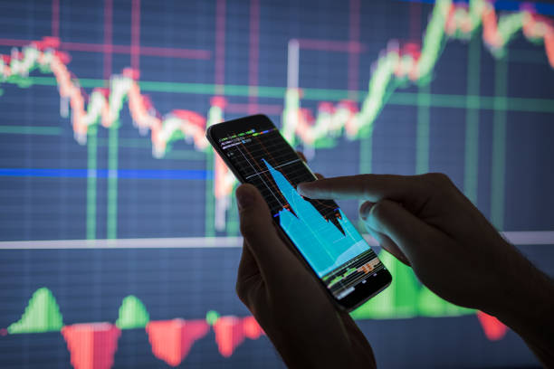 Businessman checking stock market data. Businessman checking stock market data. He using a mobile phone. Analysis economy data on forex earn graph. trader stock pictures, royalty-free photos & images