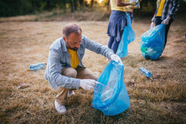 istock Volunteer with a garbage-cleaning park 826058424