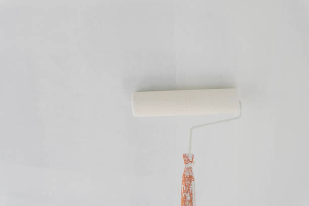 istock painting a wall with paint roller and copy space 826088188