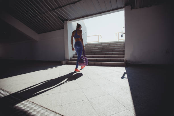 Young woman athlete on stadium entrance