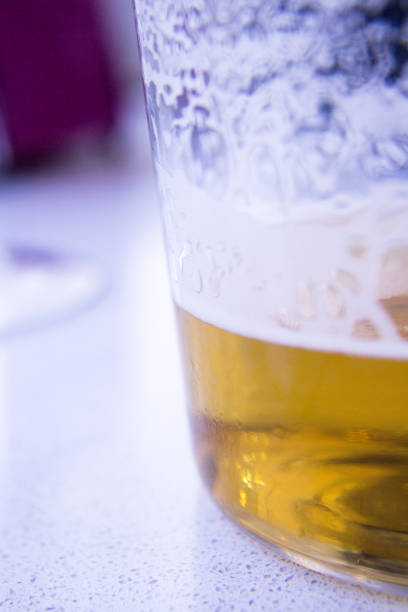 Beer glass in glass on top of a wooden table