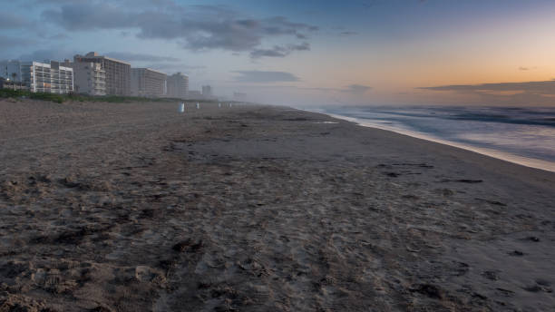 istock Ocean Side Buildings with Fog over Beach During Sunset 826120446