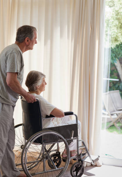 istock Retired couple looking out the window 826130270