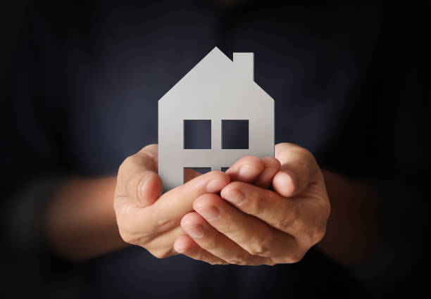 istock Mortgage concept by house from  hand 826130852