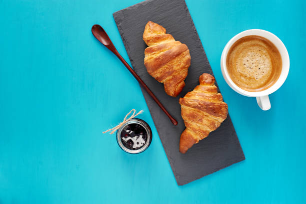istock Croissants with jam and morning coffee flat lay. 826134684
