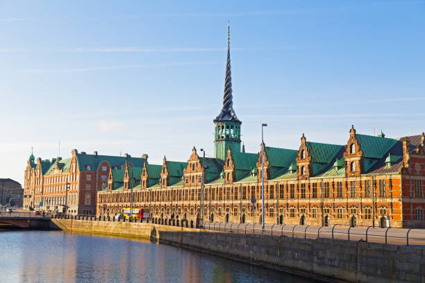 old stock exchange along the canal in copenhagen, denmark. - denmark copenhagen brick street imagens e fotografias de stock