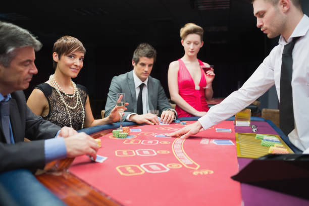 istock Woman looking up from poker game and smiling 826140416