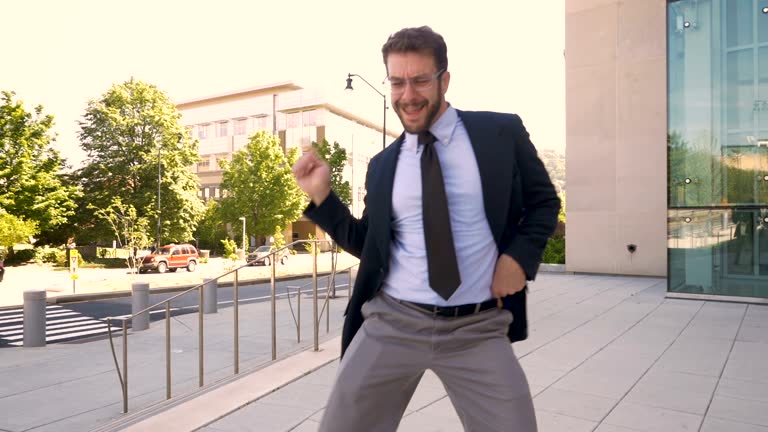 Male business executive crazy victory dancing his success and achievement