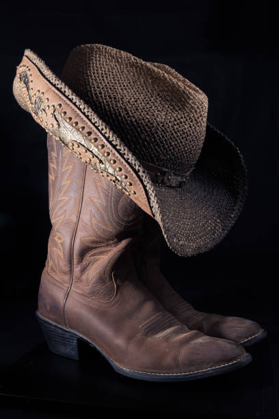 istock Worn boots and a weathered cowboy hat 826143322