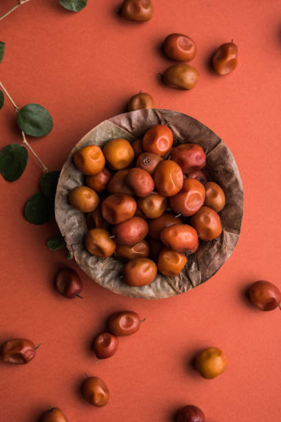 Organic Indian Jujube or ber or berry (Ziziphus mauritiana) moody lighting, selective focus Organic Indian Jujube or ber or berry (Ziziphus mauritiana) moody lighting, selective focus jujube fruit stock pictures, royalty-free photos & images