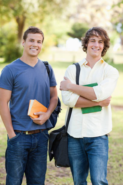istock Portrait of two standing handsome students talking 826154630